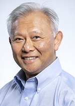 Man with short gray hair wearing a collared shirt, smiling in a professional headshot against a light background Man with short gray hair wearing a collared shirt, smiling in a professional headshot against a light background
